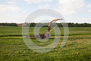 Old rusty mower in the field