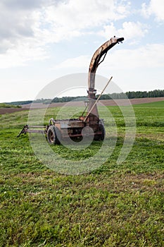 Old rusty mower in the field