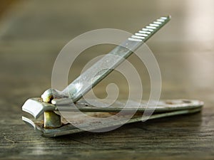 Old rusty Nail clipper on wood texture background, Close up & Macro shot, Selective focus