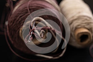 Old rusty needle and strong twine. Accessories for the leatherworker in the workshop