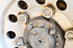 Old rusty nut and bolt on disk wheel.