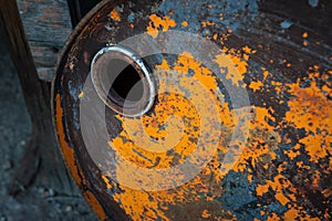 Old rusty oil barrel with orange paint