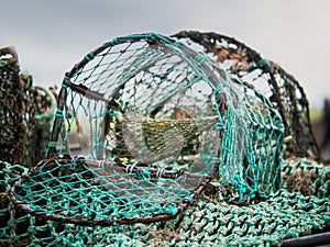 Old rusty open crab trap, Selective focus, Green torn mesh
