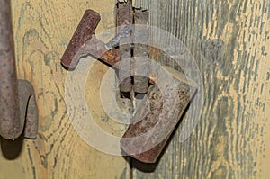 Old rusty padlock on the barn door. Long unused lock on the door.