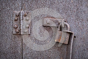 Old rusty padlock and hinge.