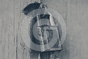 Old rusty padlock on red painted door