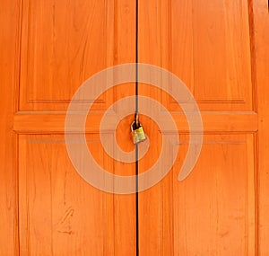 Old rusty padlock on white weathered wooden door