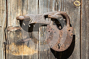 Old rusty padlock on wood brown door
