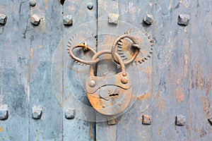 Old rusty padlock on wooden background