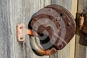 Old rusty padlock on a wooden door