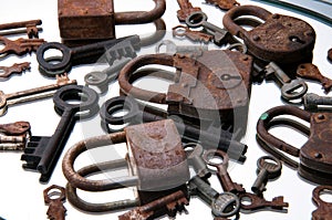 Old rusty padlocks and keys on white background. Mirror