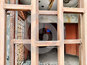 Old rusty and painted iron grating on the gate. Abstract background, pattern, frame. Texture background for design