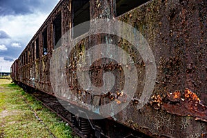 Old rusty passenger car abandoned on railway tracks