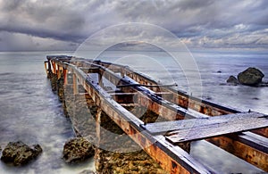 Old rusty pier in a cloudy day