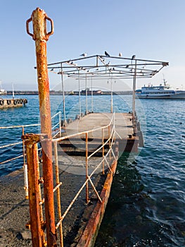 Old rusty pier for small pleasure boats