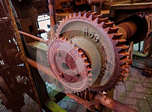 Old and rusty pinion gear of a machine in factory