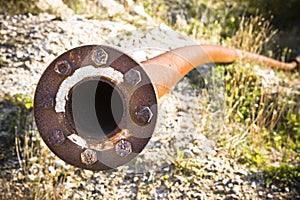 Old rusty pipeline with flange and bolts