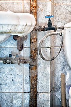 Old rusty pipes in bathroom