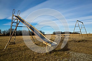 Old and rusty playground equipment sitting in the prairies of Alberta, Canada