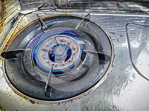 Old Rusty Propane Counter-top Gas Stove with Blue Flames