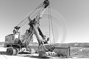 an old rusty quarry excavator is located on the territory of a mining quarry. an open method of mining