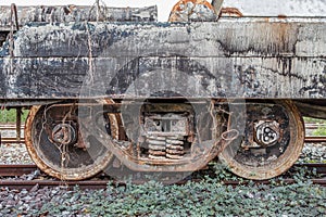 Old rusty rail wheel on railroad tracks