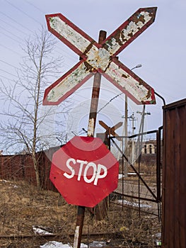 Old and rusty railroad sign with stop letters