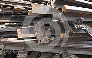 Old rusty railroad tracks for scrapping in a warehouse space