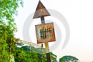 Old rusty railway level crossing signal or sign