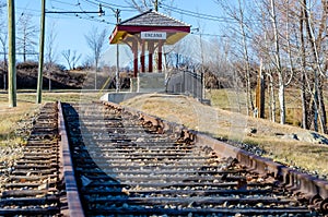 Old and rusty railway tracks and a train station