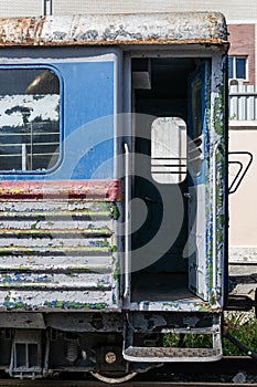 Old rusty railway wagon with an open door.