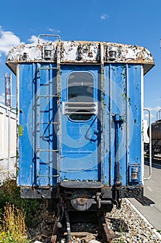 Old rusty railway wagon with an open door.