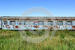 Old rusty railway wagon whit broken windows.