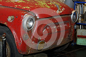 Old rusty red car