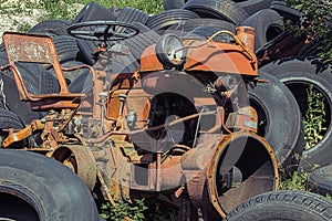 Old rusty red vintage tractor in a farm