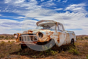 Old rusty relic car in Australian outback photo