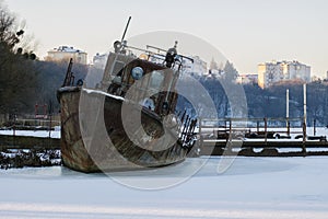 Old rusty rescue boat froze in the ice