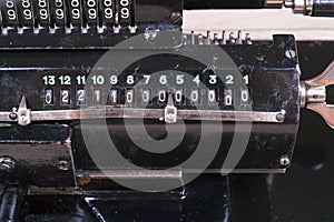 Old rusty retro calculator black standing on a wooden table