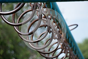 old rusty rings on a chain on a horizontal bar for gymnastics on the street, sports ground