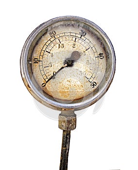 Old rusty round industrial pressure gauge with numbers round the dial isolated on white