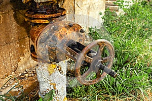 Old rusty round tap of tank closeup, outdoor