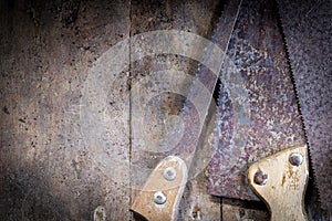 Old rusty saw blades on a wooden table