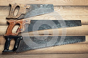 Old rusty saws on table