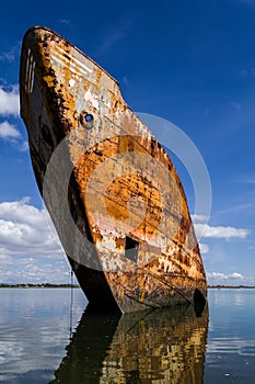 Old rusty ship run aground or beached