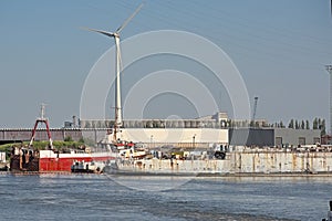 Old rusty ships being dismantled at a wharf in the harbor of Ghent