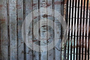 Old rusty sliding steel shutter door, grunge metal texture