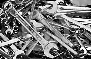 Rusty spanners and wrenches in a large pile in a toolbox