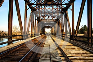Old rusty steel bridge for train and foot traffic