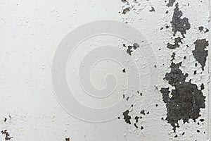 Old rusty steel surface closeup, metal wall with cracked weathered white paint. Abstract grunge texture as background for your