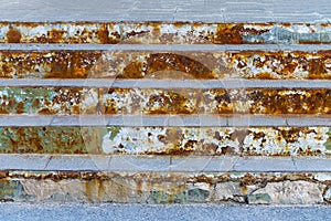 Old rusty steps in front of the building.